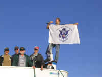 10-07-06 Ted Lailer and CG flag with 60s crewmen.jpg (85383 bytes)